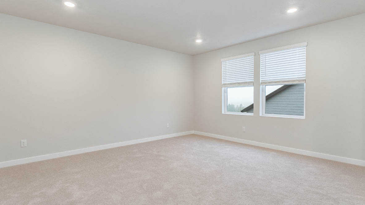 Primary bedroom with wall-to-wall carpet, a walk-in closet and an attached bathroom