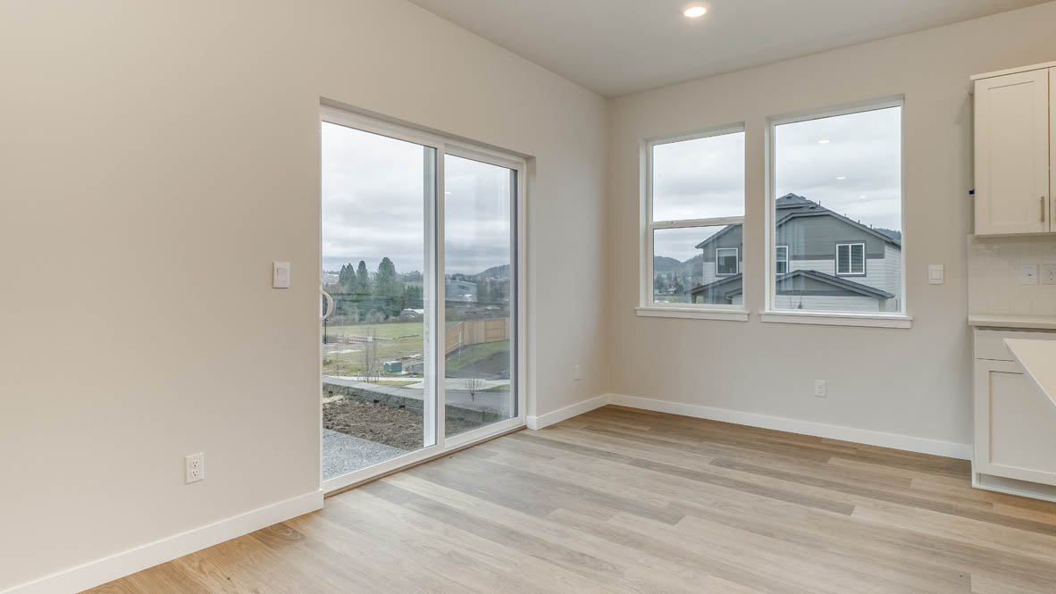 Avery Terrace dining room with laminate flooring, sliding glass door, and windows
