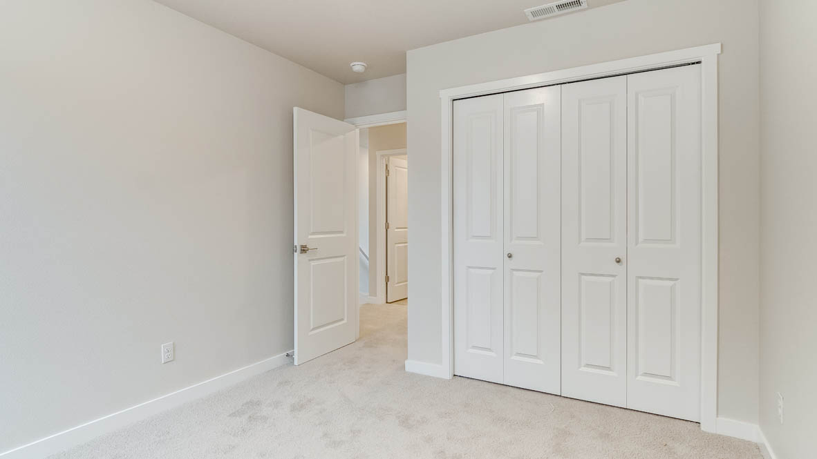 Avery Terrace bedroom with carpet, closet, and white walls