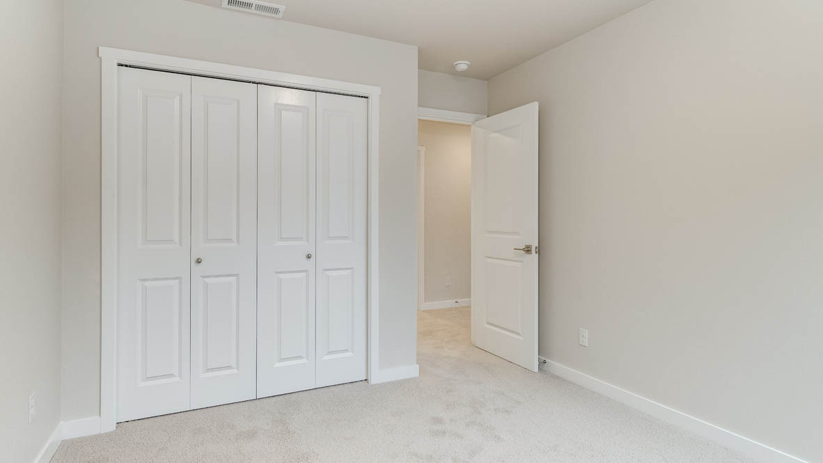Avery Terrace bedroom with carpet, closet, and white walls