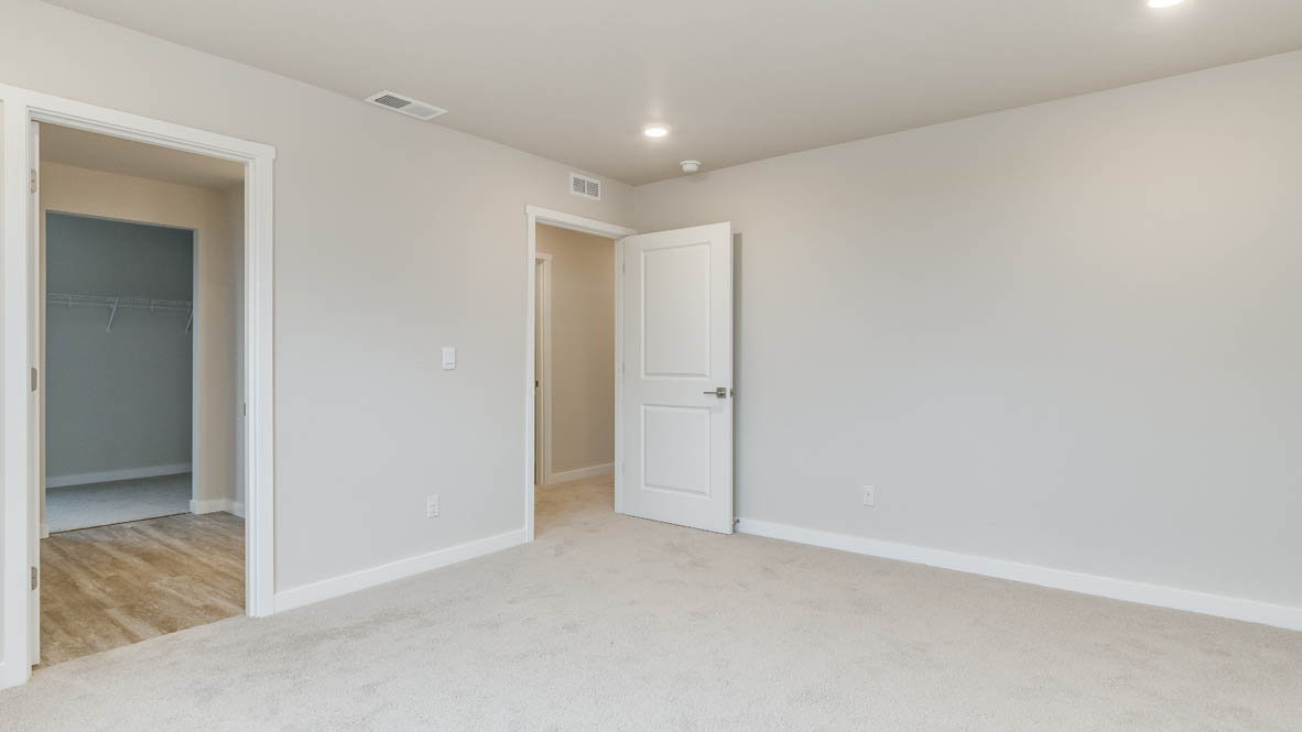 Avery Terrace primary bedroom with carpet, and the en suite bathroom in the background