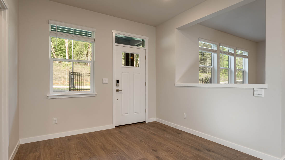 Entryway with a coat closet and laminate flooring