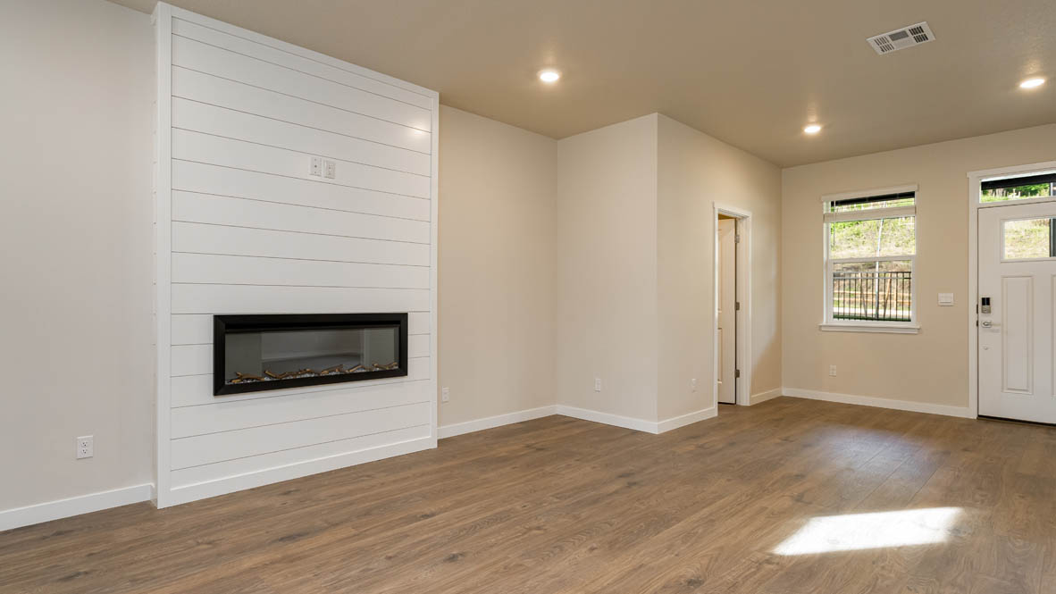 Great room with laminate flooring and an electric fireplace