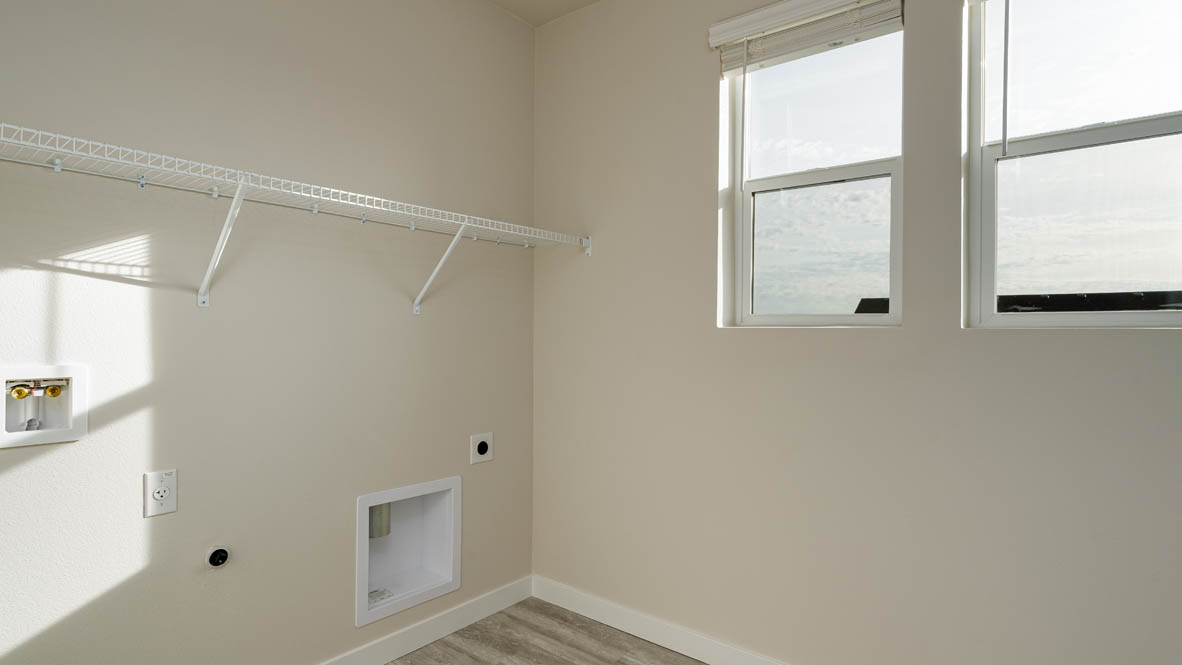 Laundry room with wire shelves and washer and dryer hookups