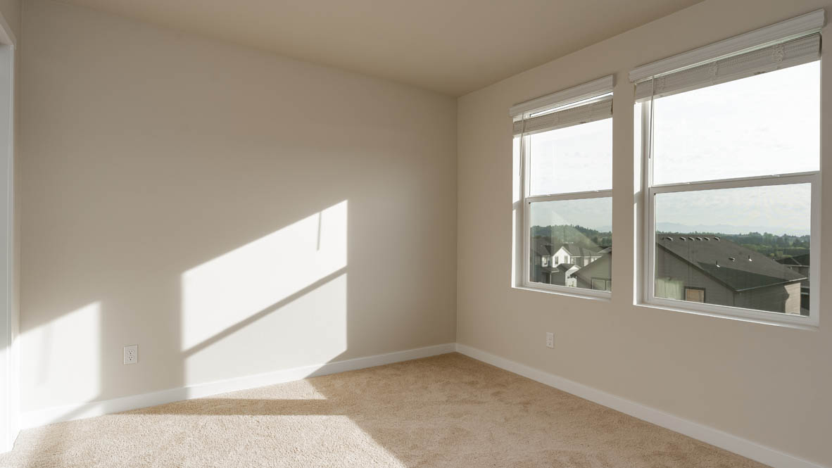Bedroom with wall-to-wall carpet and a closet