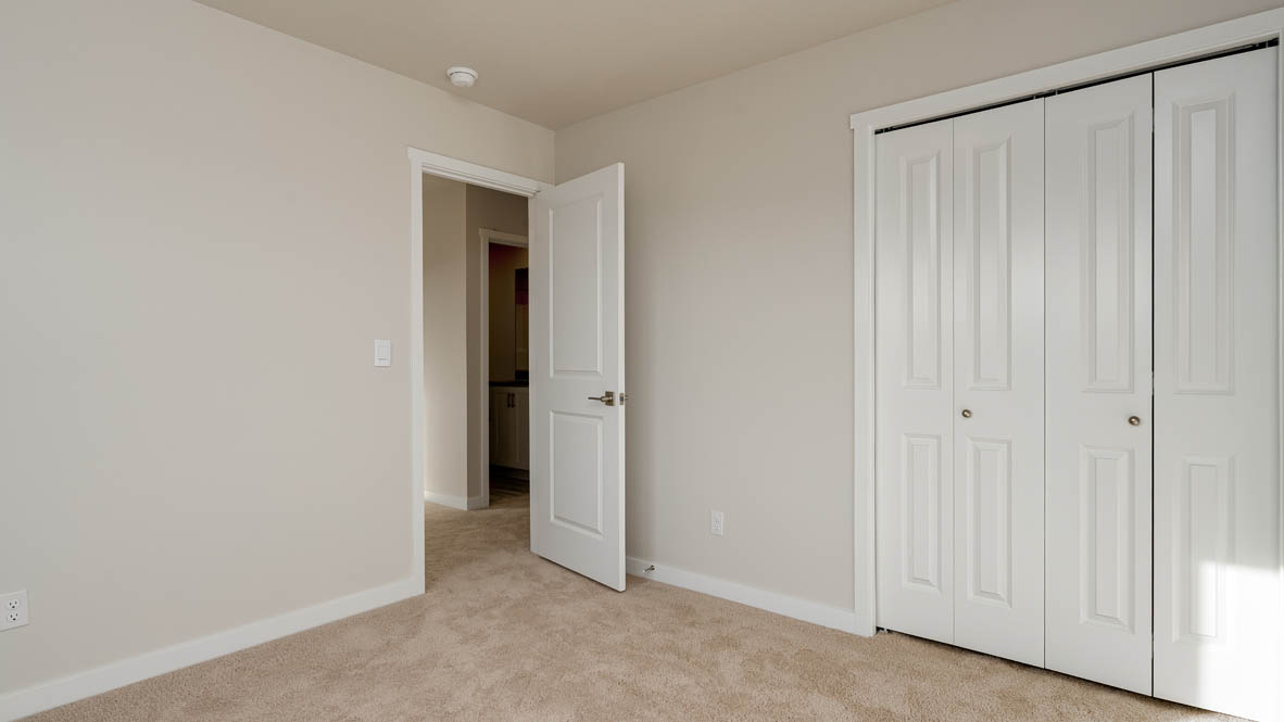 Bedroom with wall-to-wall carpet and a closet