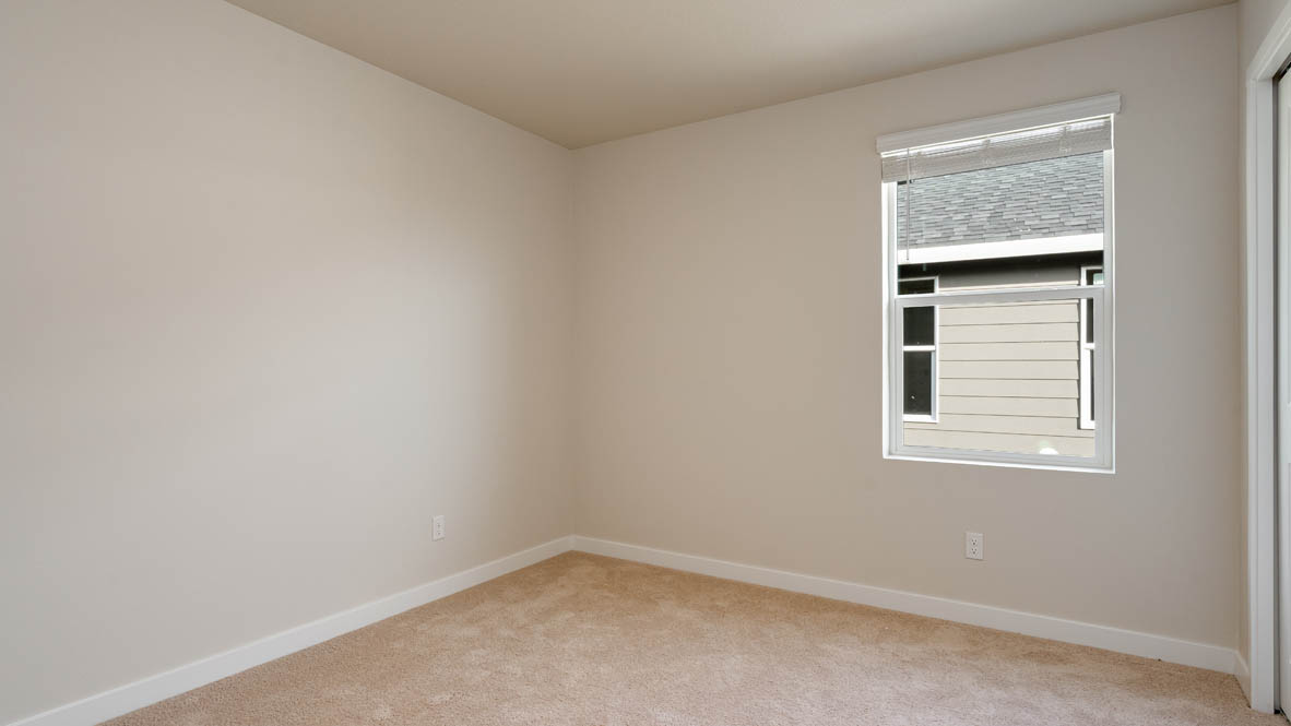 Bedroom with wall-to-wall carpet and a closet