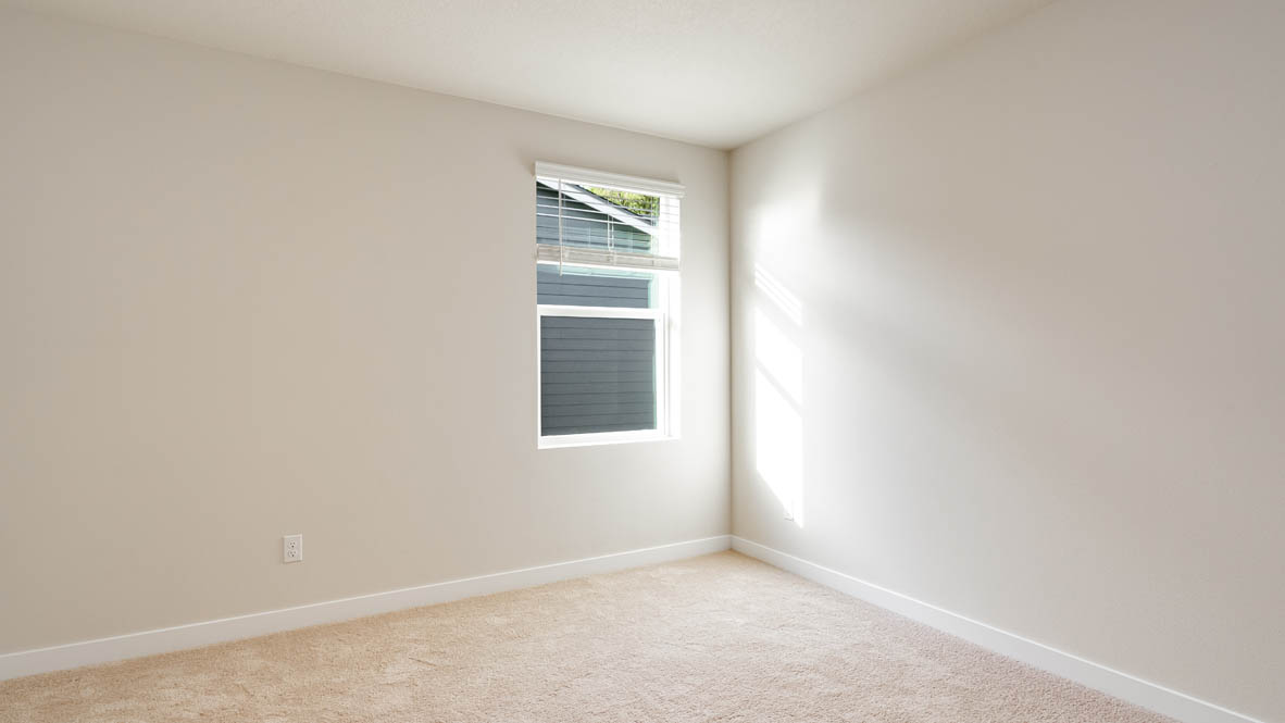 Bedroom with wall-to-wall carpet and a closet