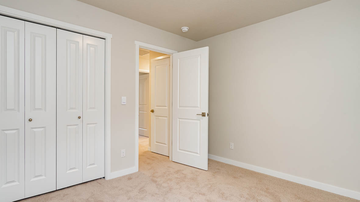 Bedroom with wall-to-wall carpet and a closet