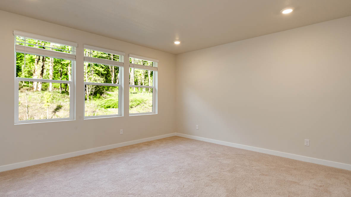Primary bedroom with wall-to-wall carpet, a walk-in closet and an attached bathroom