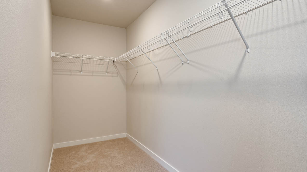 Primary bedroom walk-in closet with wire shelves