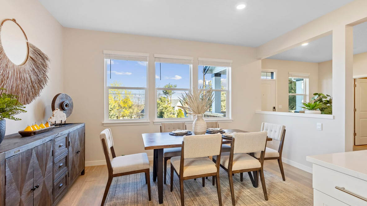 Avery Terrace Dining Room with four chairs, a table, a plant, sliding glass door, hanging decorations, a side table, a console table with plants and a mirror