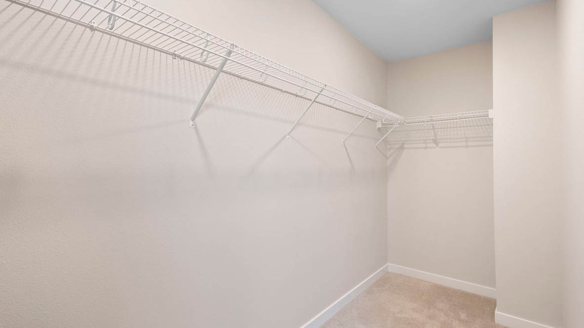 Avery Terrace walk in closet with white walls and white wire shelving
