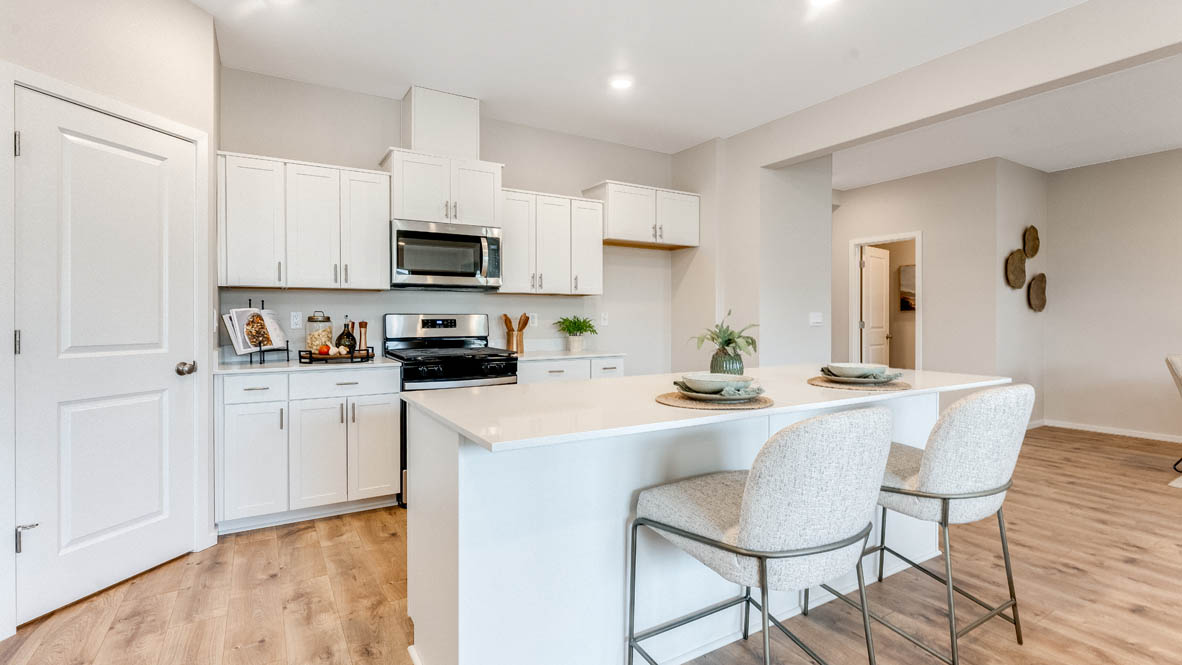 Avery Terrace Kitchen with stainless steel appliances, island, soft closed cabinets, stainless steel appliances, booth chairs