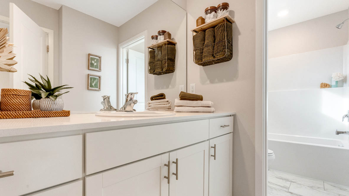 Avery Terrace Secondary bathroom with darker quartz countertops and white cabinets