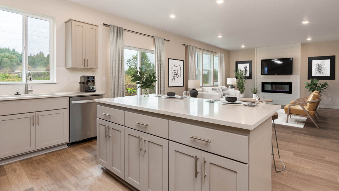 Avery Terrace kitchen with bar stools and stainless steel appliances and white shaker style cabinets