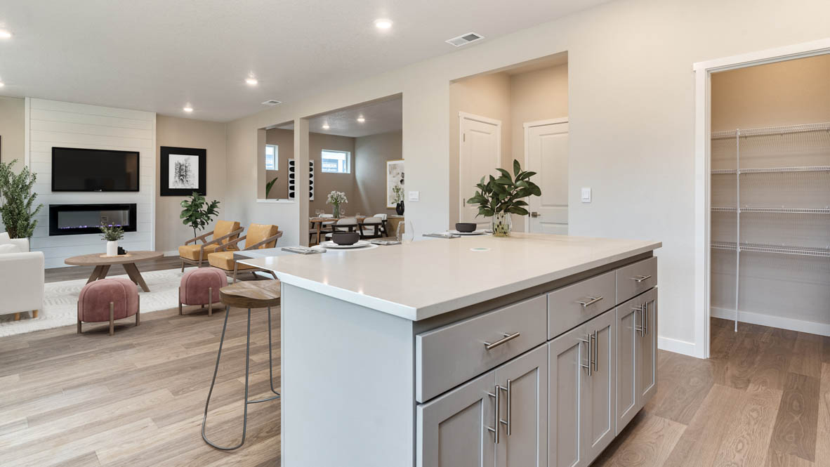 Avery Terrace kitchen with bar stools and stainless steel appliances and white shaker style cabinets