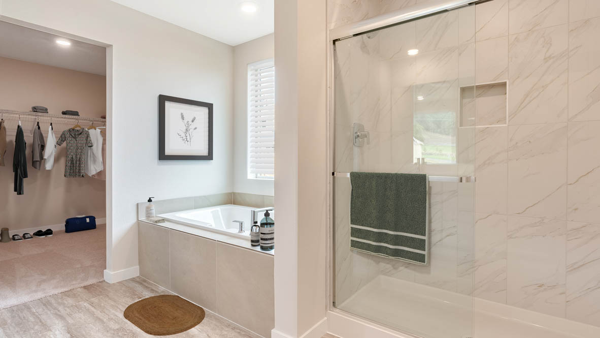 Avery Terrace primary bathroom with tub and walk in shower