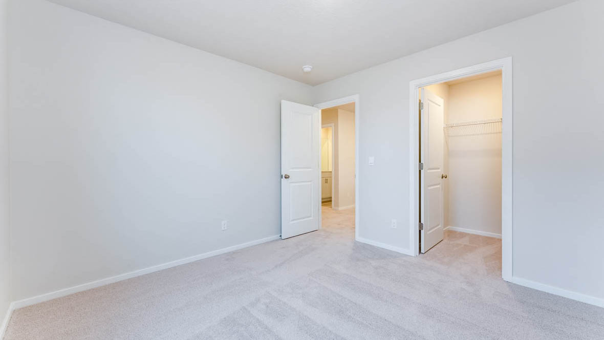 Avery Terrace bedroom with carpet, white walls, and a closet