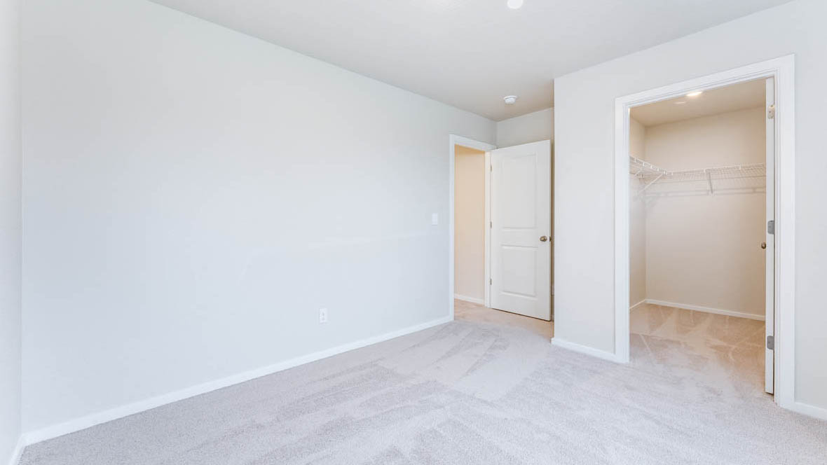 Avery Terrace bedroom with carpet, white walls, and a closet