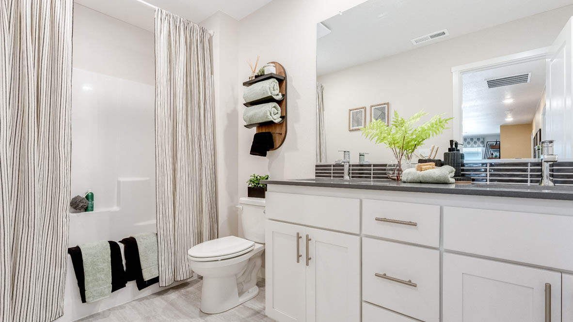 Avery Terrace Secondary bathroom with darker quartz countertops and white cabinets
