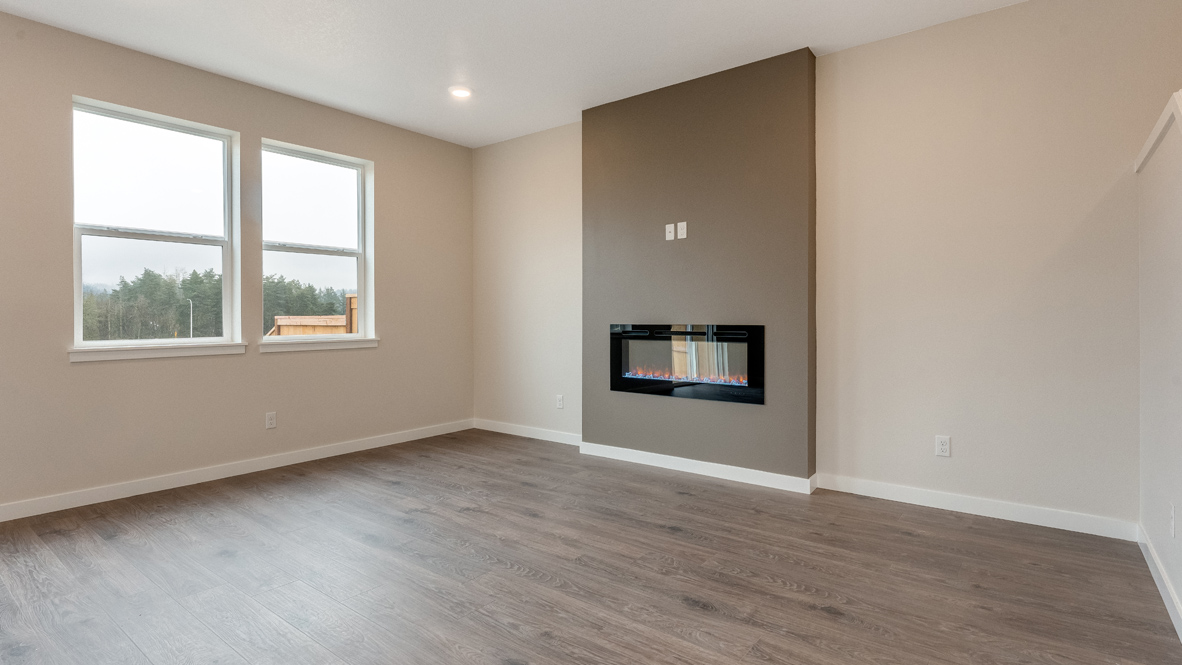Avery Terrace great room with laminate flooring, windows, electric fireplace, accent wall