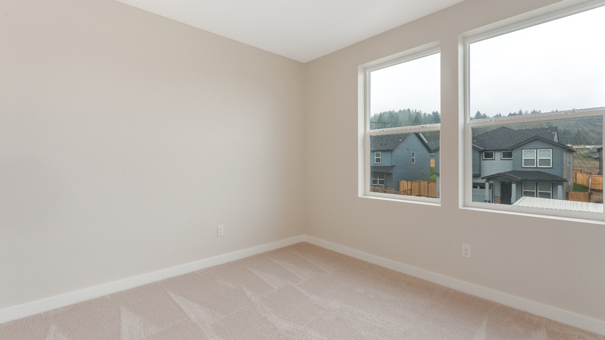 Avery Terrace bedroom with carpet, white walls, and a window