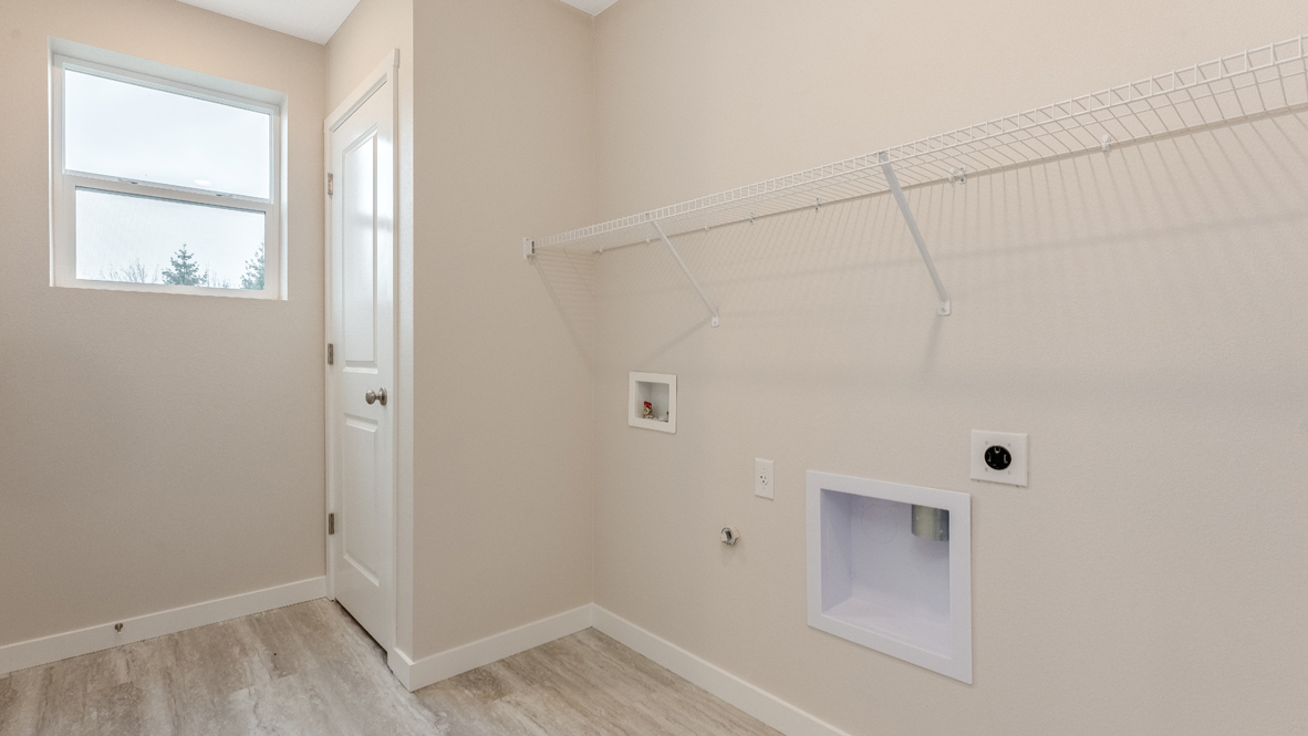 Avery Terrace laundry room with lvt flooring, window, walls, white wire shelving