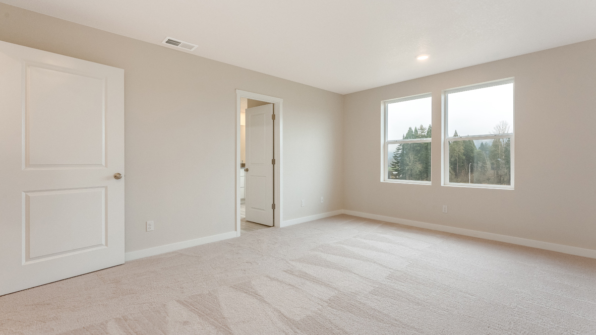 Avery Terrace primary bedroom with carpet, windows, walls, and view of bathroom