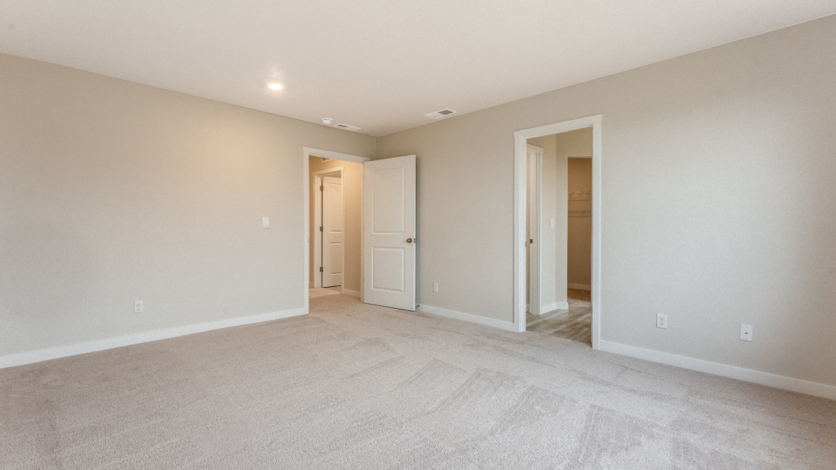 Avery Terrace primary bedroom with walls, carpet, and a door