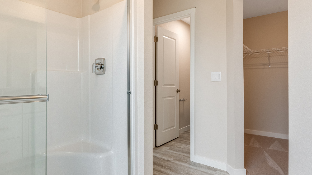 Avery Terrace primary bathroom with walk in shower, closet, and toilet