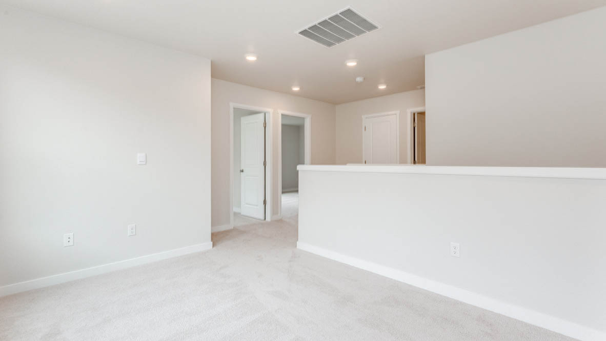 Gordon Creek Pointe loft with carpet, staircase, and white walls