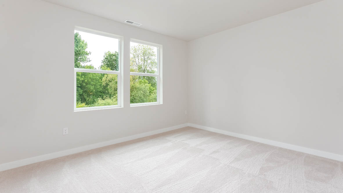 Gordon Creek Pointe Bedroom with carpet, windows, and white walls