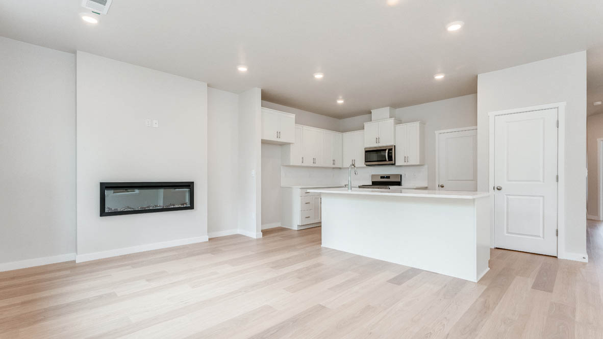 Gordon Creek Pointe Kitchen with laminate flooring, fireplace, island, stainless appliances, cabinets