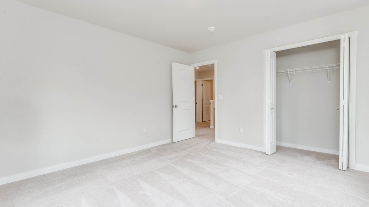 Gordon Creek Pointe Bedroom with carpet, closet, and white walls