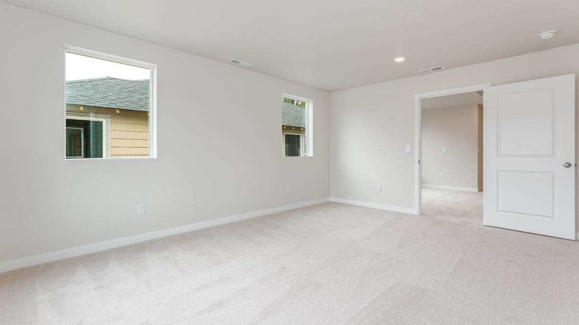 Gordon Creek Pointe Primary bedroom with windows, carpet, and white walls