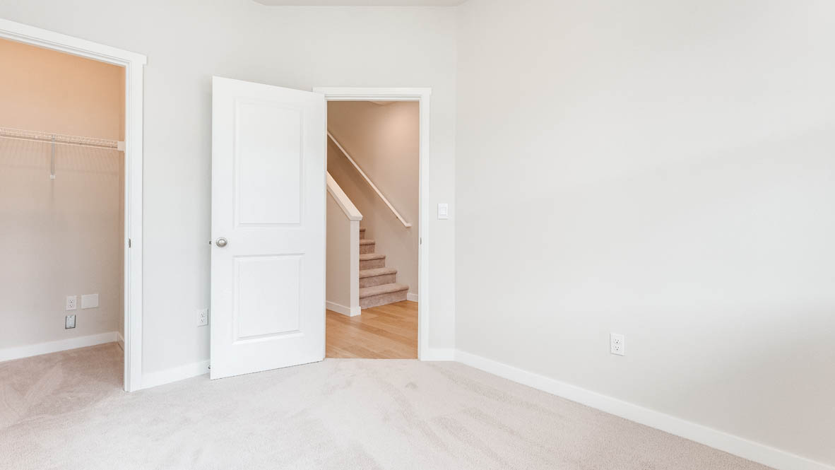 Gordon Creek Pointe Bedroom with closet, carpet, and white walls