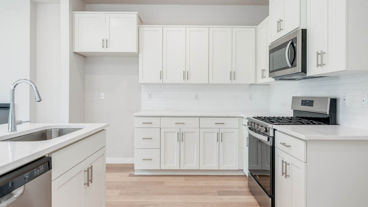 Gordon Creek Pointe Kitchen with island, quartz countertops, white shaker cabinets, and stainless steel appliances