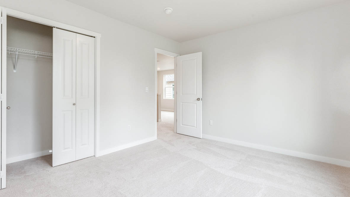Gordon Creek Pointe Bedroom with carpet, closet, and white walls
