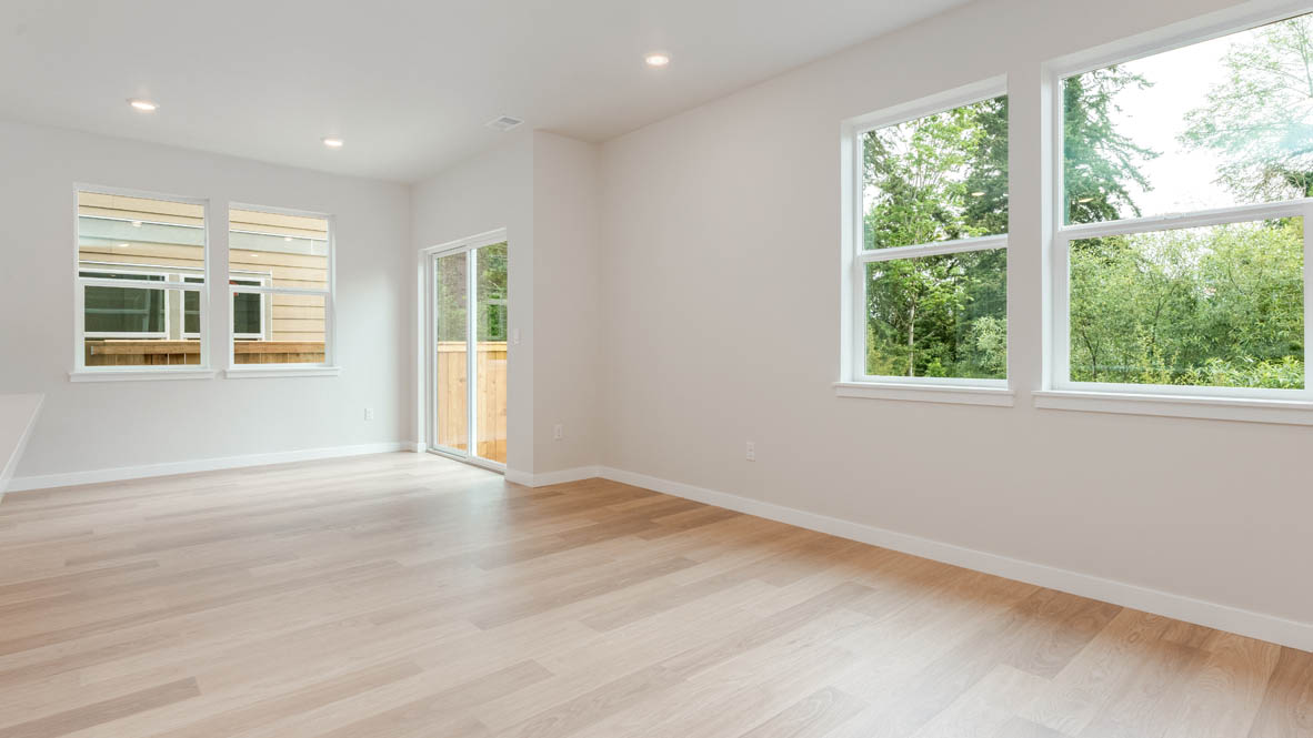 Gordon Creek Pointe dining and great room with windows, laminate flooring, and white walls