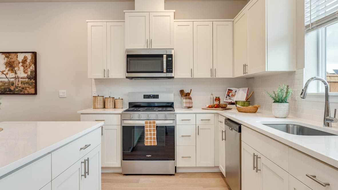 Gordon Creek Pointe kitchen with white shaker style cabinets and solid surface countertops
