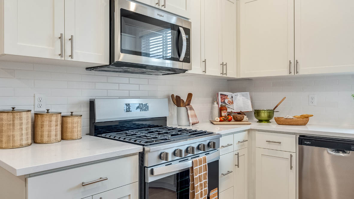 Gordon Creek Pointe kitchen with white shaker style cabinets and solid surface countertops