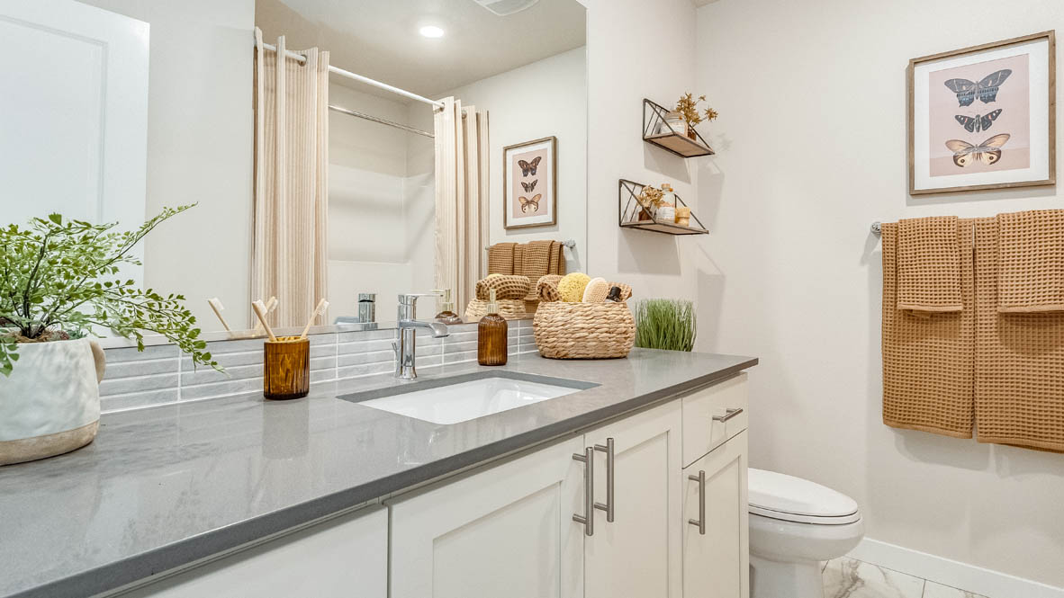 Gordon Creek Pointe secondary bathroom with gray solid surface countertops