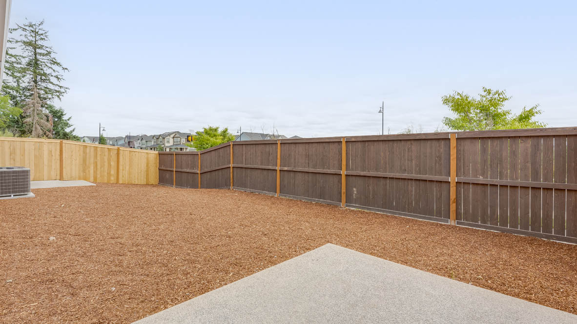 Gordon Creek Point backyard with bark and pavement