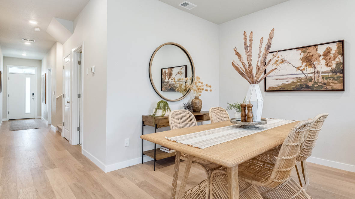 Gordon Creek Pointe Dining Room with a dining table, four chairs, a mirror, decor plant, painting