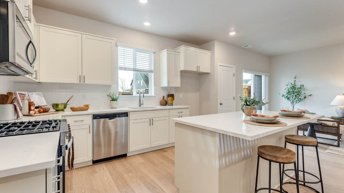 Gordon Creek Pointe kitchen with white shaker style cabinets and solid surface countertops