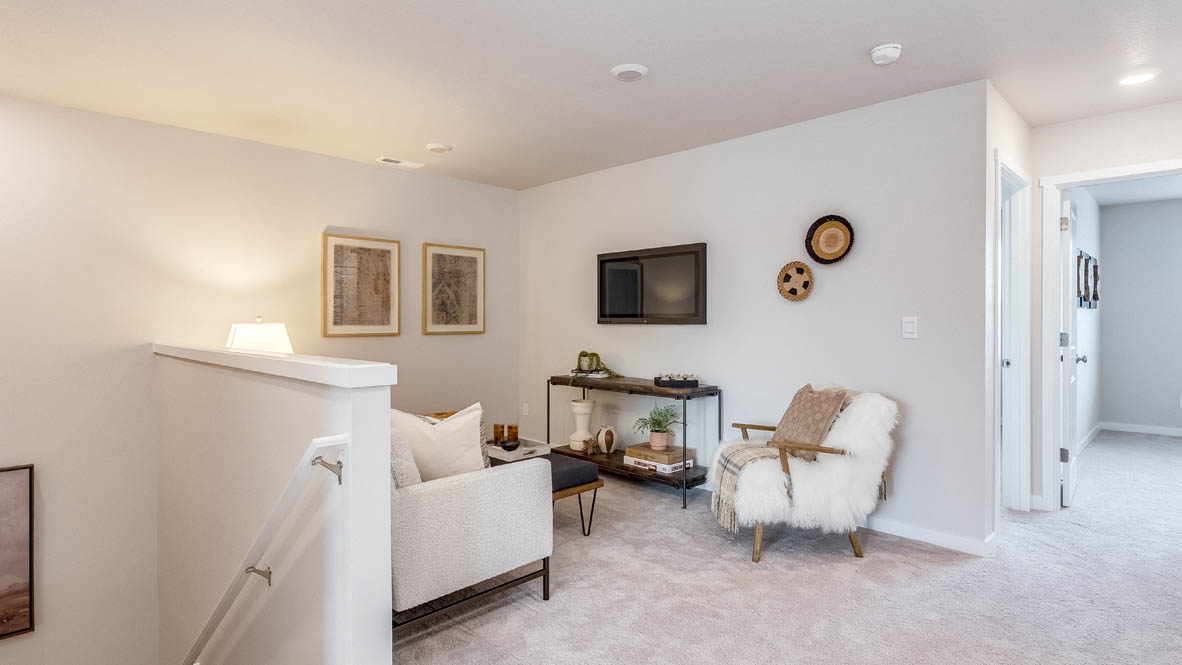 Gordon Creek Pointe loft with carpeting next to the stairs, a tv, couch, chair, tv stand, and decor