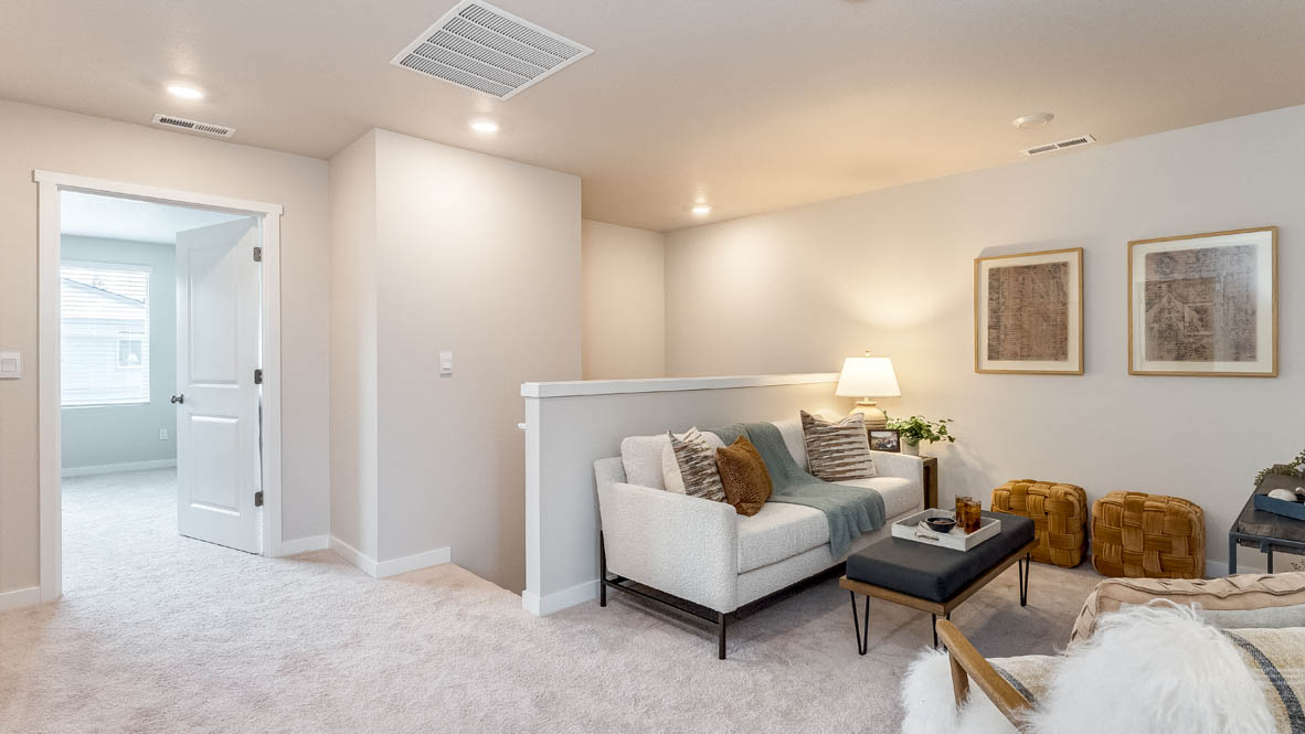 Gordon Creek Pointe loft with carpeting next to the stairs, a tv, couch, chair, tv stand, and decor