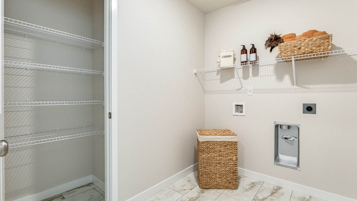 Gordon Creek Pointe laundry room with storage, hamper, and white wire shelving