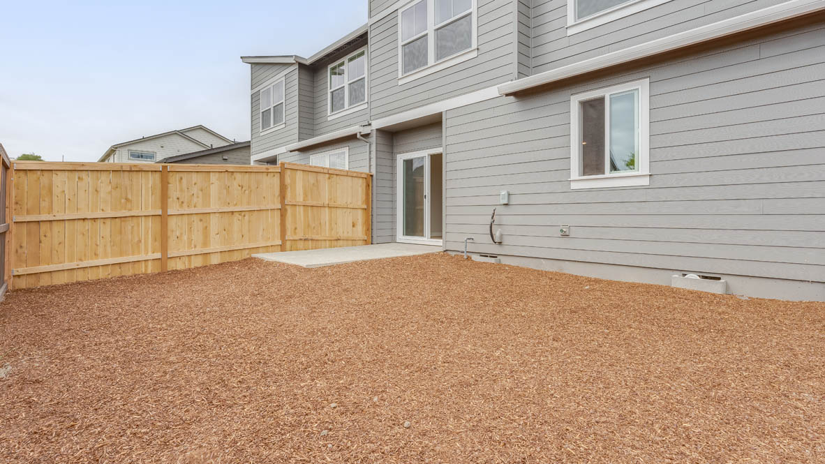 Gordon Creek Pointe backyard with bark and pavement